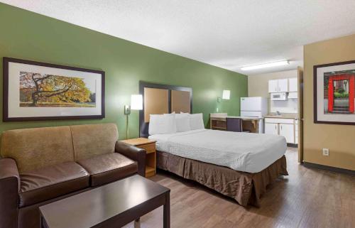 a hotel room with a bed and a couch at Extended Stay America Select Suites - Denver - Aurora South in Aurora