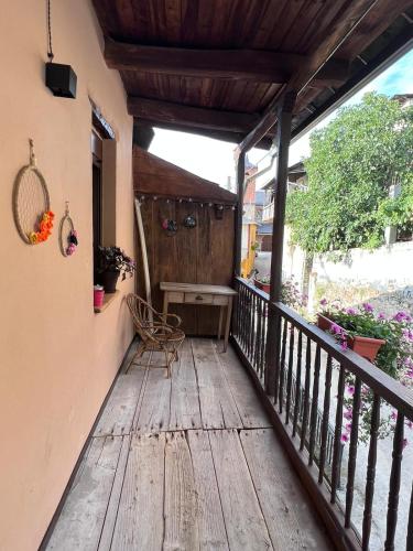 a porch with a wooden deck with a bench on it at El Rincón del Val in Priaranza del Bierzo