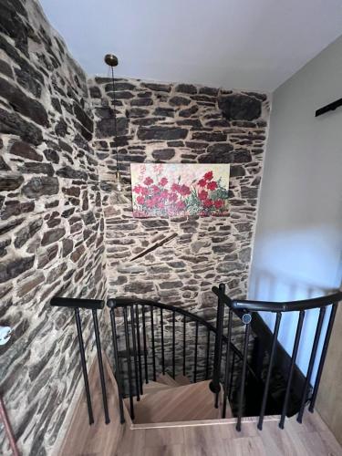 a stone wall next to a staircase in a room at El Rincón del Val in Priaranza del Bierzo