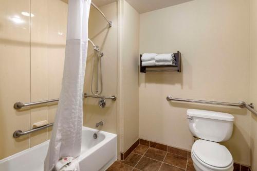 a bathroom with a toilet and a tub and a shower at Comfort Suites in Clovis