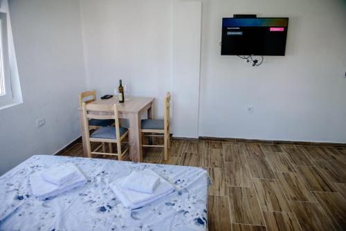 a room with a bed and a table and a tv at Premium Apartments in Žabljak