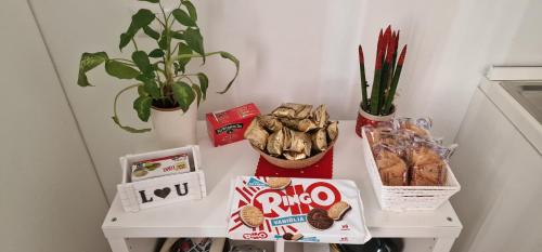 a small white table with snacks and plants on it at La Perla di Ele in Bari