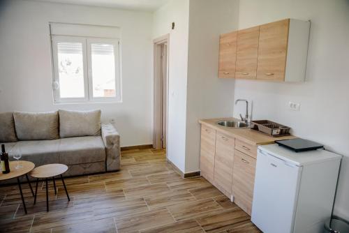 a kitchen and living room with a couch and a table at Premium Apartments in Žabljak