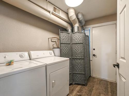 a laundry room with a washing machine and a shower at Heart of Westport 1BR in Kansas City