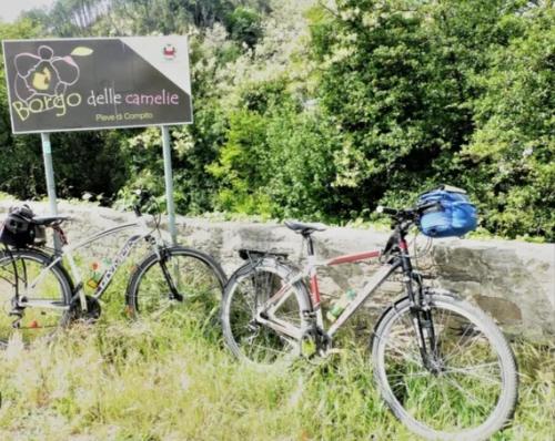 two bikes are parked next to a sign at Antico Casale Masini in SantʼAndrea di Compito