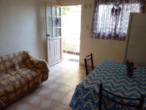 a living room with a couch and a table at Buenos Aires Tango Apartment near Golf in San Antonio de Padua