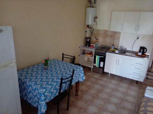 a kitchen with a table and a kitchen with a stove at Buenos Aires Tango Apartment near Golf in San Antonio de Padua