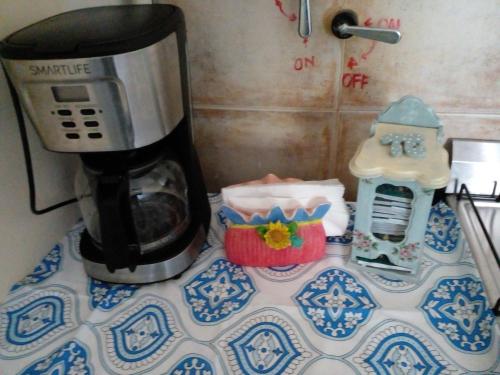 a coffee maker on top of a table with a coffee pot at Buenos Aires Tango Apartment near Golf in San Antonio de Padua