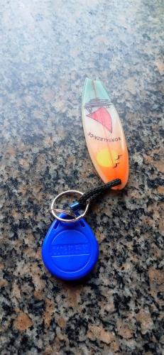 a pair of keys sitting on top of a surfboard at Buenos Aires Tango Apartment near Golf in San Antonio de Padua