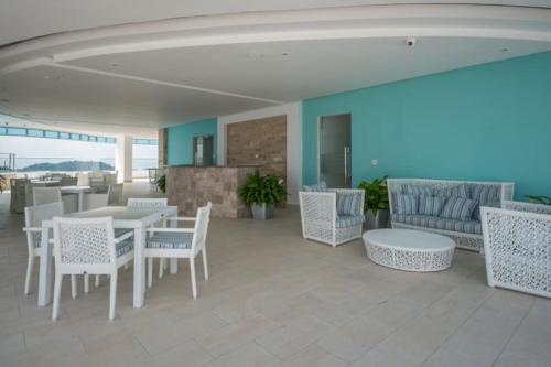 a living room with a table and chairs and a couch at 13B Spectacular Oceanview Resort Lifestyle Panama in ArraijÃ¡n