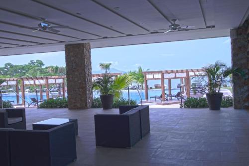 a lobby with chairs and a view of the water at 13B Spectacular Oceanview Resort Lifestyle Panama in ArraijÃ¡n