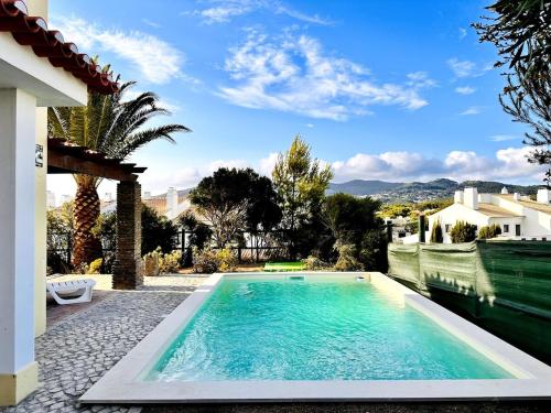a swimming pool in the yard of a house at Aldeia de Juzo Cascais Villa in Aldeia de Juso
