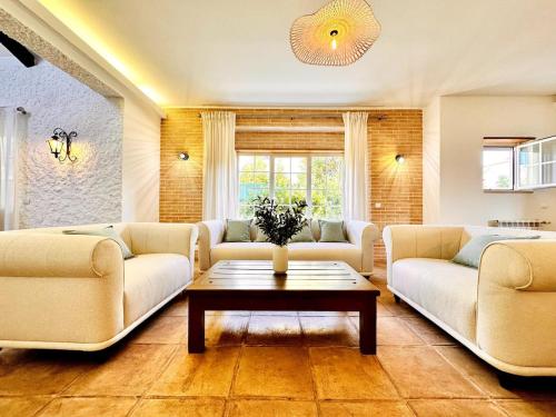 a living room with two couches and a coffee table at Aldeia de Juzo Cascais Villa in Aldeia de Juso