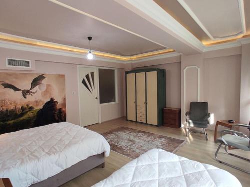 a bedroom with a bed and a painting on the wall at Cozy 1+1 and garden, in center of İstanbul in Istanbul