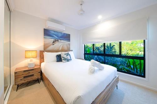 a bedroom with a large bed and a window at 3 Bedroom Holiday Home Valley Views in Airlie Beach in Airlie Beach