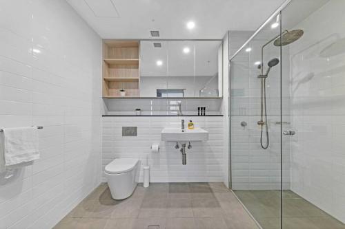 a bathroom with a toilet and a sink and a shower at Entire Apartment in Ryde in Sydney