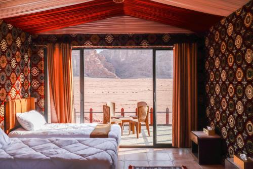 a living room with a couch and a table and chairs at Magic Bedouin Star in Wadi Rum