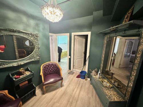 a living room with a mirror and a chair at Luxury House City Center in Trabzon