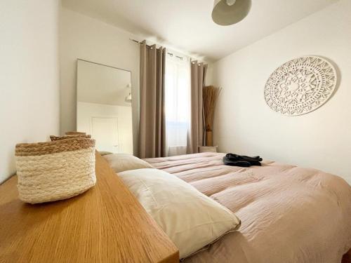 a bedroom with a large bed with a wooden table at Suite Topaze in Lyon