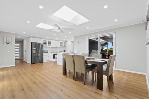 a kitchen and dining room with a table and chairs at Sunseeker on Tambo in Metung
