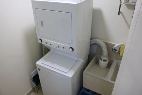 a white machine in a bathroom with a sink at 15B Stunning Oceanfront Views Panama Resort Life in ArraijÃ¡n