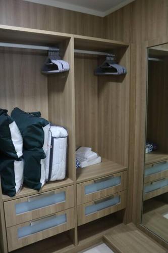 a locker room with a mirror and some towels at 16H Luxury Oceanview Playa Bonita Resort Panama in ArraijÃ¡n