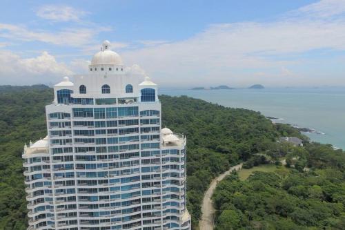 a large white building with a dome on top of it at 16H Luxury Oceanview Playa Bonita Resort Panama in ArraijÃ¡n