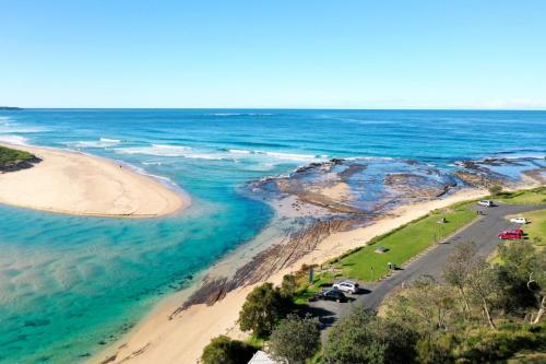 an aerial view of a beach and the ocean at Break Away in Burrill Lake