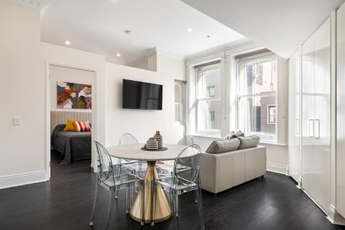 a living room with a table and a couch at Orange Stay Apartments Potts Point in Sydney