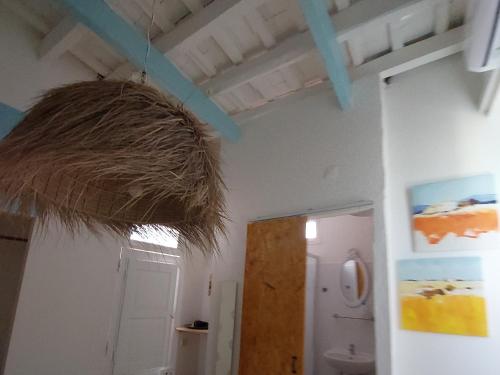 a room with a large straw basket hanging from the ceiling at Casarão AL in Olhão