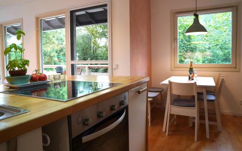 a kitchen with a counter and a table with a bottle of wine at Sjö Hus in KÃ¶hn