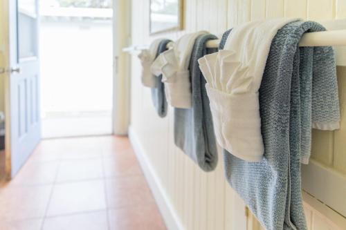 a rack of clothes hanging on a wall at OceanFront Kauai - Harmony TVNC 4247 in Kapaa