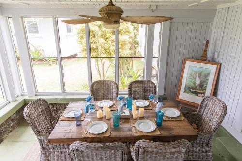 a dining room table with chairs and a table with food at OceanFront Kauai - Harmony TVNC 4247 in Kapaa
