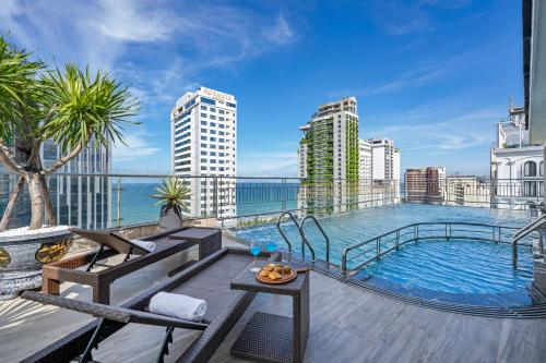 a balcony with a swimming pool on top of a building at Monalisa Luxury Hotel in Danang