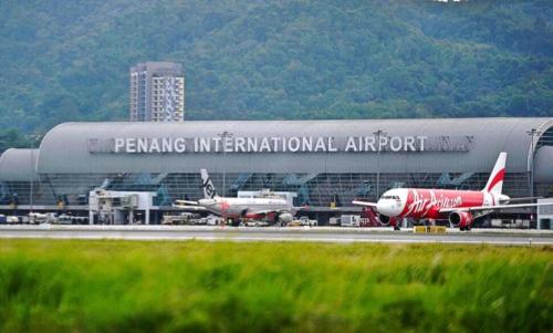 an airport with two airplanes on a runway at Homestay Taman Lagenda Padang Serai in Padang Serai