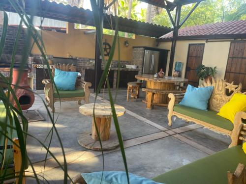 a patio with couches and a table and a table at Palapa Bajazul in Loreto