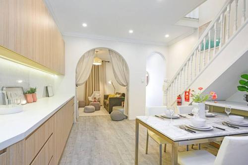 a kitchen with a table and a living room at Cozy 3 bedroom terrace in CBD in Sydney