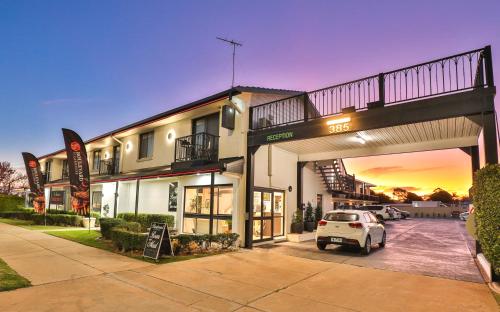 a white car parked in front of a building at Boulevard Motor Inn in Mildura