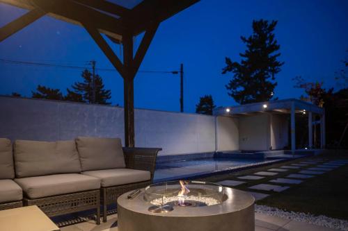 a living room with a couch and a fire pit at Mezzo ALL SUITE VILLAS in Miyazu