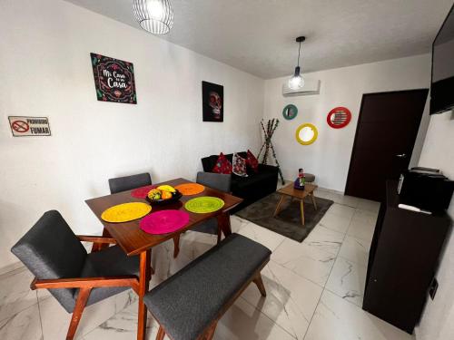 a living room with a dining room table and chairs at Rincón del sol depa en Manzanillo colima in Manzanillo