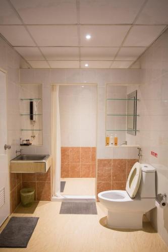 a bathroom with a toilet and a shower and a sink at Phimai Paradise Boutique Hotel in Nakhon Ratchasima