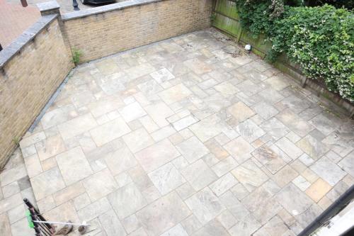 an overhead view of a patio with a brick wall at rooms close to central london in London