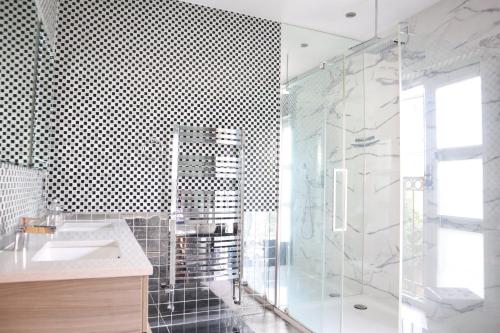 a bathroom with a sink and a glass shower at rooms close to central london in London