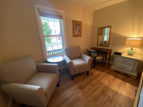 a living room with a couch and a chair and a table at Centre Gate House Licence# 117-2023 in Niagara on the Lake