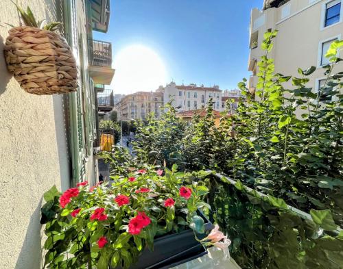 a balcony filled with flowers and plants on a building at Coziness in The Center of Nice - T2 with AC in Nice