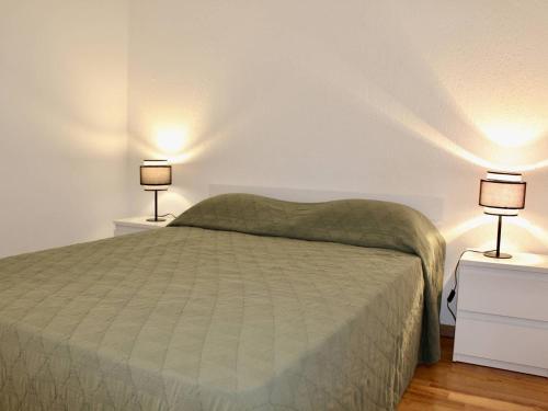 a bedroom with a bed and two lamps on night stands at Appartement Villeneuve-Loubet, 2 pièces, 4 personnes - FR-1-252A-113 in Villeneuve-Loubet