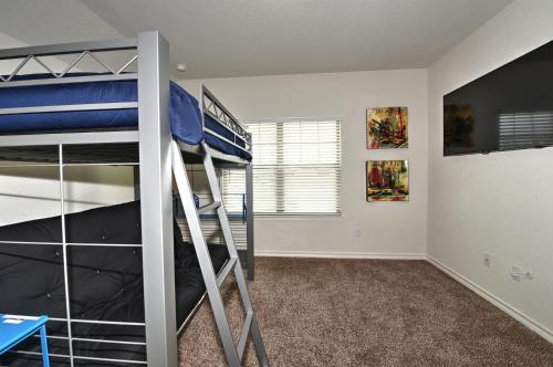 a bedroom with a bunk bed and a ladder toweredwered at New 3 Bedroom Vacation Home Lackland/Sea World/La Cantera in San Antonio