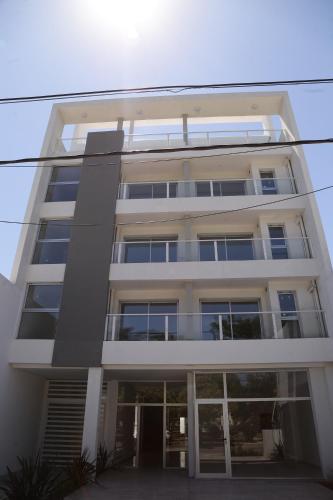 a tall white building with a lot of windows at MI LUGAR * CHIVILCOY in Chivilcoy