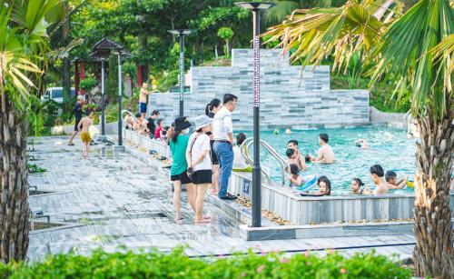 a group of people in a pool at a resort at Khách sạn Đại Dương Diễn Châu - Nghệ An in Diễn Châu