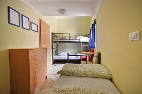 a bedroom with a bed and a bunk bed at Hostel X Point in Kobarid